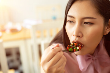 Woman eats Chili spicy and hanging on spoon to mouth