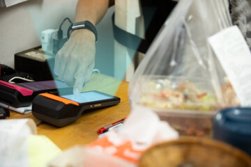 Hand on Food Delivery Online Order System Machine at restaurant