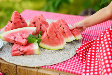 Cute child eats ripe juicy watermelon at summertime. Child, baby, healthy food snack for children.