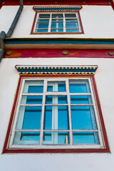 traditional ornament.  windows with wooden carvings on the windows in a wooden house