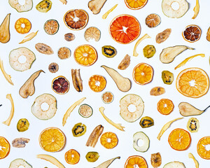 Dried mixed fruits seamless pattern on white background. Dried apples, oranges, limes, avocados, pears, kiwi, bananas. Delicious and healthy snack.