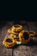 Quince cookies on rustic wooden board and black background
