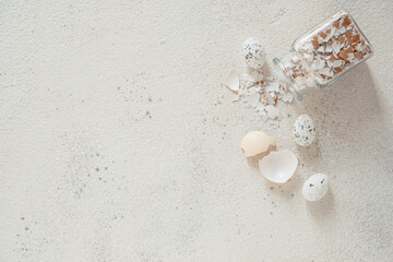 eggshell in a glass jar scattered on the table. top view