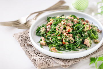 Warm agretti salad with pancetta, parsley and almonds