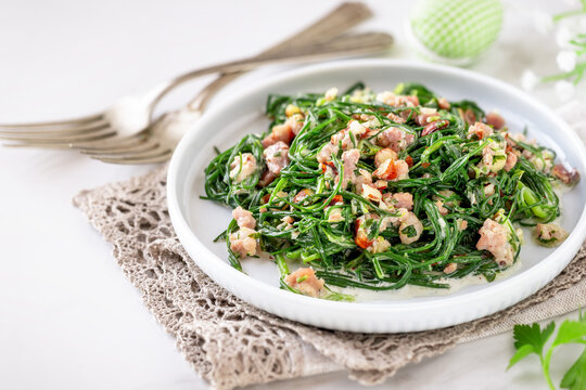 Warm agretti salad with pancetta, parsley and almonds