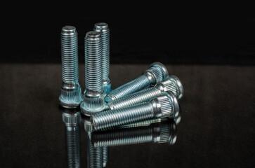 close-up on black background studs for fastening car wheels