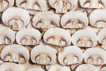 Young mushrooms champignons, sliced into plates, close-up, background