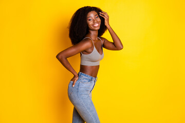 Photo of charming coquette lady hand pocket look camera wear cropped top isolated yellow color...