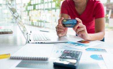 Fototapeta premium Close up of Hands holding credit card and using laptop for Online shopping