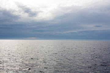 Blue sea or ocean water surface, underwater with sunny and cloudy sky