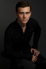 Obraz premium a young dark-haired man in a black shirt