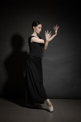 dramatic vintage portrait of a girl dancing ballerina in a black dress
