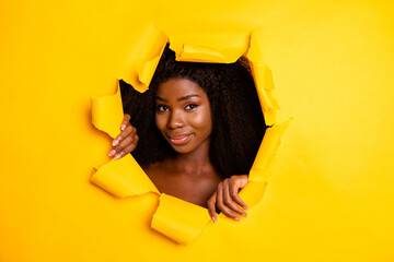 Photo of sensual flawless lady hands torn hole look camera through ripped vivid yellow color background