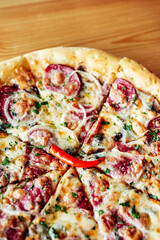 pizza in a plate on a wooden brown table