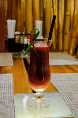 A glass of delicious mint cocktail made of fresh fruit on the table in the cafe.