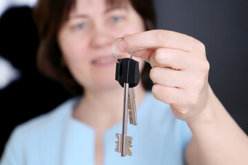 Real estate agent, apartment keys in female hands. Happy woman, concept of purchase or rental home