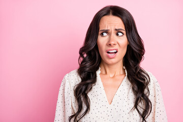 Portrait of unsatisfied questioned girl look empty space open mouth isolated on pink color...