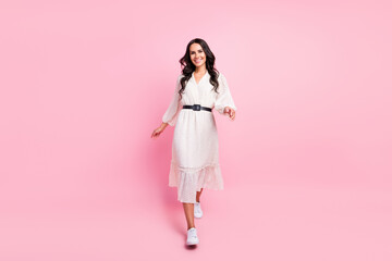 Full body photo of charming happy young lady walk weekend spring isolated on pastel pink color background