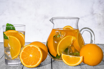 Healthy orange detox with fresh orange and lime, in glass.