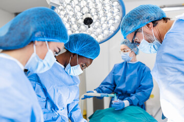 Medical team of surgeons in hospital doing minimal invasive surgical interventions. Surgery...