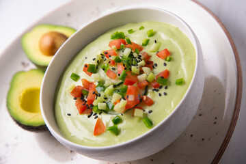 Avocado soup with yogurt and vegetables.