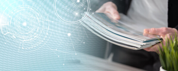 Male hands holding magazines; panoramic banner