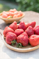 White strawberry and Red strawberry in basket on wooden background ,Fresh white strawberry, Japan fresh white strawberries.