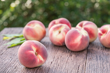 Fresh Peach fruits on wooden table in blur background, Peach  on wooden table in garden.