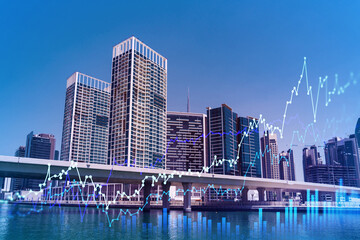 Skyscrapers of Dubai business downtown. International hub of trading and financial services of Western Asia. FOREX graph and chart concept. Double exposure. Dubai Canal waterfront.