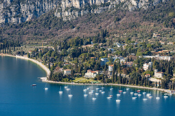 Fototapeta premium Aerial view of the small Garda town, tourist resort on the coast of homonymous Lake Garda, view from the Rocca di Garda, small hill overlooking the lake. Verona province, Veneto, Italy, Europe.