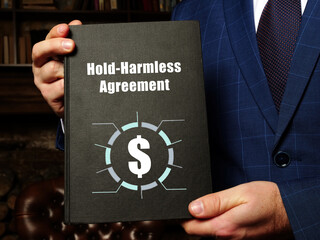 Business concept meaning Hold-Harmless Agreement with inscription on the black notepad.