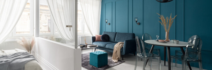 Living room with teal blue wall, panorama