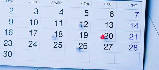 Calendar page pinned in a calender on datebusiness meeting schedule, travel planning or project milestone and reminder concept.
