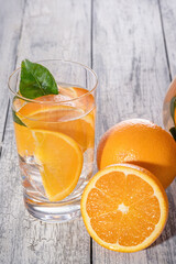 Healthy orange detox with fresh orange and lime, in glass.
