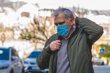 casual adult man with medical mask protecting from coronavirus around the city