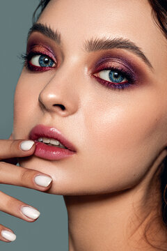 Close-up portrait of a beautiful woman with evening makeup. Strong skin texture. Natural skin, clean healthy skin.