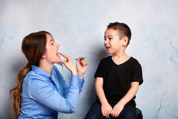 Correction of pronunciation with speech therapist. Concept over blue  background.