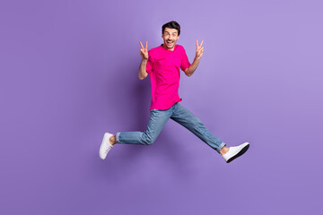 Fototapeta na wymiar Full size portrait of excited crazy guy two hands fingers show v-sign toothy smile isolated on purple color background