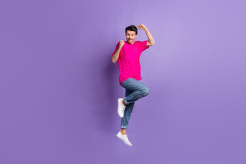 Full body photo of delighted cheerful man fists up beaming smile celebrate isolated on violet color background