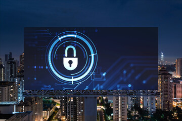 Padlock icon hologram on road billboard over panorama city view of Kuala Lumpur at night to protect...