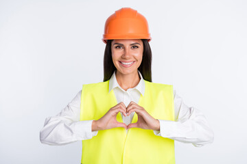 Photo of affectionate worker lady fingers show heart symbol wear helmet shirt vest isolated white color background