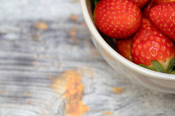 Berries of fresh juicy strawberries on wooden background