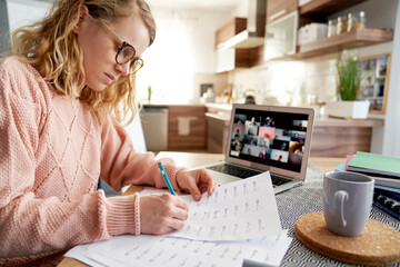 Female teacher evaluates math tasks while homeschooling