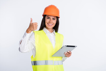 Photo of promoter lady hold tablet raise thumb up wear helmet shirt vest isolated white color background