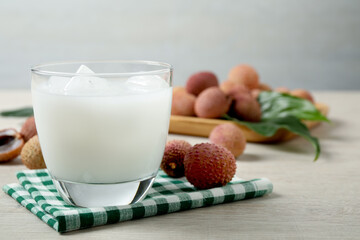 Fresh lychee juice on white wooden table