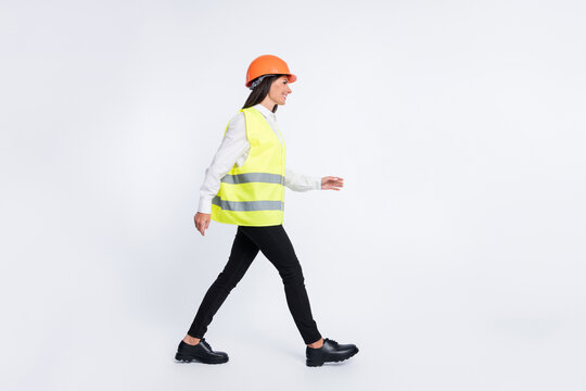 Profile Photo Of Lovely Worker Lady Walk Look Empty Space Wear Helmet Shirt Vest Isolated White Color Background
