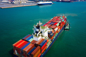 container ship sailing in green sea and  tugboat drag  shipping to seaport
