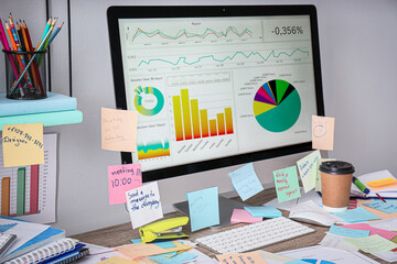 Computer, notes and office stationery in mess on desk, space for text. Overwhelmed with work