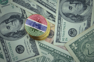 golden shining bitcoins with flag of gambia on a dollar money background.