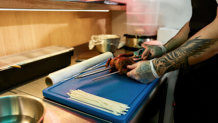 Chef preparing grilled chicken in a restaurant